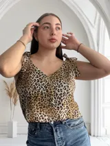 Blusa con estampado animal print, escote en V y tiras con nudo en los hombros.