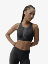 Top deportivo de sujeción alta, confeccionado en tejido Shapplex_B compacto y ligero. Presenta un diseño de cuello redondo, espalda deportiva con abertura para mayor transpirabilidad y cierre ajustable. Incluye detalles reflectantes en el frente y la espalda.