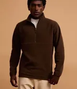 Saco masculino de fleece color marrón oscuro, con cuello alto y cremallera frontal parcial. Presenta manga larga y detalles de recortes horizontales en el pecho.