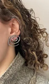 Par de caravanas plateadas con forma de espiral.