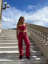 Pantalón rojo de cuero sintético con flecos largos en los laterales.