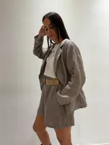 Short de lino color rojo, con cintura elástica y cinturón de rafia con hebilla circular.