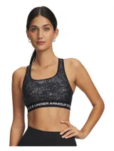 Top deportivo de soporte medio con diseño de espalda cruzada. Presenta un estampado jaspeado en tonos negros y grises, con una banda elástica inferior negra que incluye el logo de la marca en letras blancas. Confeccionado en tejido HeatGear de doble capa, de secado rápido y alta transpirabilidad.