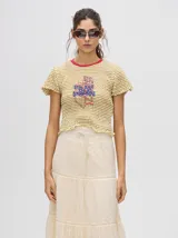 Falda larga blanca de broderie de algodón con detalle de galones con transparencias, pretina elástica con cordones ajustables y forro jacquard.