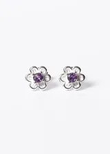 Par de aros tipo caravana de plata 925 con forma de flor y zirconia cúbica violeta en el centro.