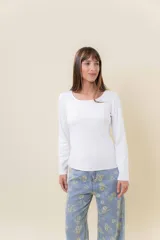 Remera básica de manga larga en color blanco, confeccionada en tela gruesa con elastano. Presenta un diseño liso con escote redondo y un calce cómodo que se adapta al cuerpo sin ajustar.