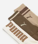 Kit de tres pares de medias deportivas Puma de caña larga, confeccionadas en algodón. Incluye un par blanco con rayas y logo azules, un par negro con rayas y logo blancos, y un par liso de color azul.