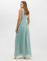 Vestido largo de gasa con hilo metalizado lurex, color beige, con escote en V cruzado y drapeado, cintura alta con aplicaciones de strass y falda larga plisada con movimiento.