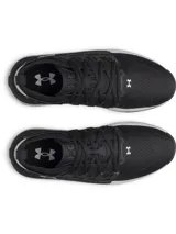 Championes Under Armour Phantom X de hombre, color negro con entresuela blanca y detalles en gris. Cuentan con parte superior de tejido transpirable, estructura de TPU en el mediopié con el logo de la marca en blanco y amortiguación de espuma.