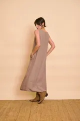 Vestido largo color verde petróleo con escote en V, detalles de bordado metálico en el escote y bolsillos laterales.