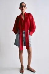 Shorts de denim de tiro alto y corte relaxed fit de Zara Woman Collection, en color celeste con lavado claro. Presenta trabillas en la cintura, cinco bolsillos, detalles de pliegues frontales y cierre con cremallera y botón metálico.