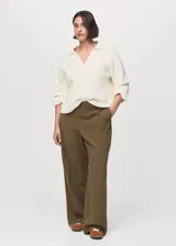 Pantalón sastrero de tiro medio, color marrón, con diseño recto, bolsillos laterales y trabillas para cinturón. Cuenta con cierre oculto de botón, gancho y cremallera.