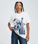 Remera de algodón de manga corta y cuello redondo, con estampado frontal de un gato gigante estilo Godzilla sobre un edificio icónico.