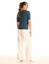 Buzo tejido marca Tahari, color verde, con cuello a la base, manga corta y diseño de ochos en el frente.