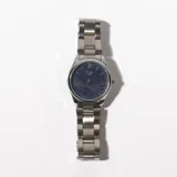 Reloj de pulsera plateado con esfera azul texturizada y agujas plateadas.