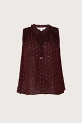 Blusa sin mangas de color bordó con estampado de pequeños puntos dorados. Presenta un cuello con detalle de volados, escote con cordones ajustables y un diseño holgado y fluido.
