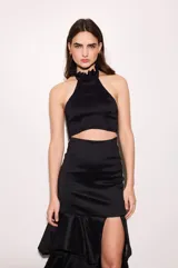 Top de tafeta color negro con escote halter y volados en el cuello, ajuste al cuerpo, espalda baja y cierre con botones.