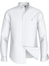 Camisa blanca de popelina de algodón con tecnología Flex que proporciona elasticidad en cuatro direcciones. Tiene cuello con botones, puños redondeados con botón y logo de Tommy Hilfiger bordado en el pecho.