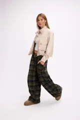 Campera corta de cuero sintético en color beige, con diseño de calce relajado, cierre frontal metálico, bolsillos con solapa en el frente y cordón ajustable en el ruedo.