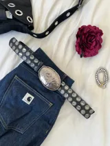 Cinturón negro de cuero sintético con hebilla irregular plateada.