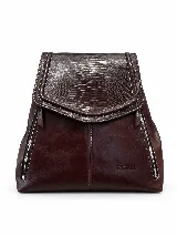 Mochila de cuero vacuno marrón con acabado pulido, solapa en forma de V y costuras decorativas. Cuenta con cremalleras laterales y asas ajustables.