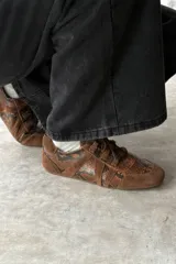 Championes urbanos modelo Nini en color bordó, combinando paneles de gamuza y textura símil piel de reptil con cordones al tono.