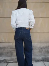 Pantalón jean de tiro medio, corte recto y amplio con caída estilo wide leg, en tono azul clásico.