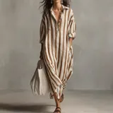 Vestido camisero maxi de corte holgado y manga larga, con diseño de rayas verticales en tonos blanco y marrón, cuello camisero y escote en V.