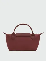 Cartera pouch Le Pliage de Longchamp, modelo compacto en color bordó con asa superior corta y cierre de solapa con botón a presión.