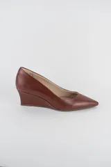 Zapatos cerrados de ecocuero color marrón, con punta fina y taco corrido.