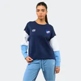 Buzo de cuello redondo Umbro del Club Nacional de Football, con diseño de bloques de color en azul marino, blanco y celeste. Presenta el logo de la marca y el escudo del club bordados en el pecho.