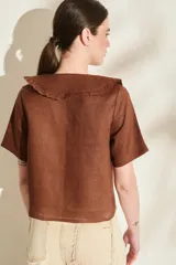 Blusa de lino color rojo, con mangas cortas, cuello en V con solapa redonda fruncida y cierre frontal de botones.