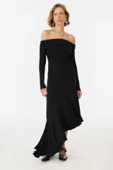 Vestido midi negro con escote off-shoulder, mangas largas y falda con volados asimétricos.