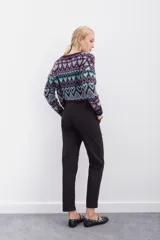 Pantalón blanco de tiro alto con elástico interno en la cintura, botones falsos y terminación con volado. Tiene bolsillos aplicados en delantero y falsos en espalda.