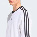 Camiseta Adidas Originals de corte holgado, color blanco con cuello redondo acanalado en negro y las icónicas tres tiras negras en las mangas. Presenta el logo del trifolio bordado en el centro del pecho.