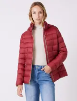 Campera puffer Michael Kors de color blanco, con diseño acolchado, cierre frontal metálico, bolsillos laterales con cierre y capucha desmontable. Incluye bolsa autoportante para guardado.