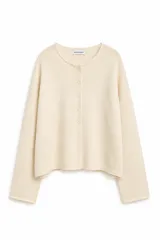 Cardigan de punto color crema, con cuello redondo, cierre frontal de botones y mangas largas de corte holgado.