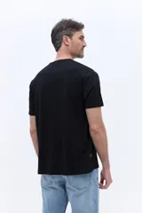 Remera de algodón color negro, con cuello redondo, mangas cortas y bolsillo frontal con logo estampado.