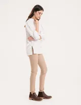 Pantalón chupín color beige de gabardina elastizada con tajitos frontales en el ruedo, pierna recta justa y bolsillos laterales.