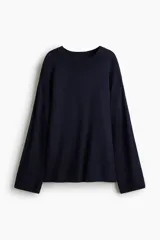 Buzo de punto fino color azul marino, con cuello redondo, hombros caídos y remates acanalados en puños y bajo.