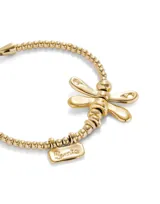 Pulsera dorada elástica con dije de libélula y dije rectangular con la inscripción "Sweet".