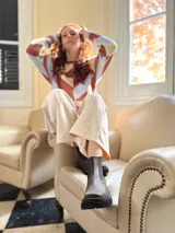 Sweater de punto con diseño geométrico en tonos celeste, marrón y beige.