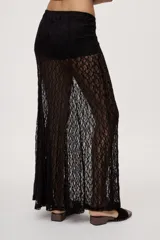 Falda larga de encaje negro semitransparente, de tiro medio y diseño amplio con textura floral.