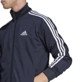 Conjunto deportivo Adidas compuesto por una campera con cierre frontal y cuello alto, y un pantalón de jogging. Ambas piezas presentan el diseño clásico de tres bandas blancas en los laterales y el logo de la marca bordado.