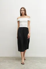 Vestido midi de corte recto, con top blanco de escote bardot y falda negra.