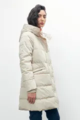 Campera capitoneada color beige, con capucha y cierre frontal con botones a presión.