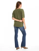 Blusa de silueta fluida con escote en V, manga japonesa corta y costura central vertical en el frente. Confeccionada en tejido de punto con acabado mate, presenta un diseño con largo asimétrico, siendo más larga en la espalda.