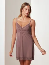 Chemise color lila con breteles finos regulables y apliques de encaje en el escote y el ruedo.