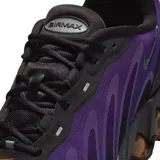 Championes Nike Air Max Dn8 de diseño moderno y deportivo. Presentan una combinación de colores en negro y violeta, con una suela técnica que incorpora cápsulas de aire visibles en tono bronce para mayor amortiguación.