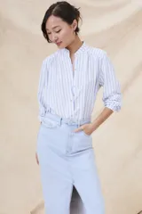 Camisa de manga larga con cuello mao y estampado a rayas verticales celestes y blancas.